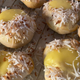 Rolls with custard and toasted coconut, called school bread, are displayed